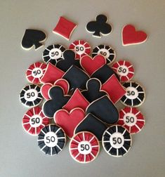 some cookies that are shaped like casino chips and playing cards with the numbers 50 on them