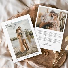 two wedding photos are laying on a wood slice with flowers in the foreground and an envelope that says thank you