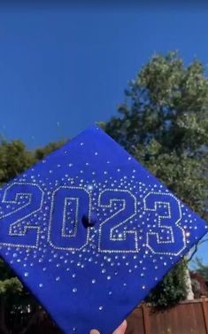 a blue graduation cap with the numbers 2013 on it