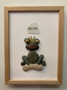 a frog sitting on top of a rock in a frame