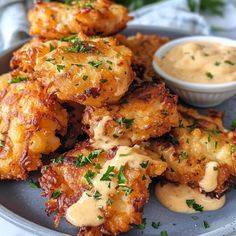 some fried food is on a plate with dipping sauce