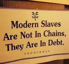 there is a sign that says modern slaves are not in chains they are in debt