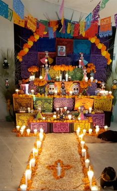 a decorated altar with candles and decorations on the floor for day of the dead celebrations