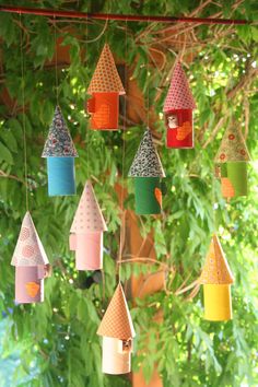 colorful bird houses hanging from a tree branch