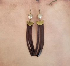 These gorgeous earrings have a drop length of 5.25 inches. The brown fringe is genuine leather. This is the perfect style for anyone looking for a bold, bohemian look. If you like this piece please click on my shop to see more inspired designs and give me a follow! Elegant Brown Adjustable Tassel Earrings, Elegant Leather Fringe Jewelry, Elegant Brown Dangle Tassel Earrings, Adjustable Leather Tassel Earrings, Bold Bohemian, Brown Fringe, Bohemian Look, Perfect Style, Leather Fringe