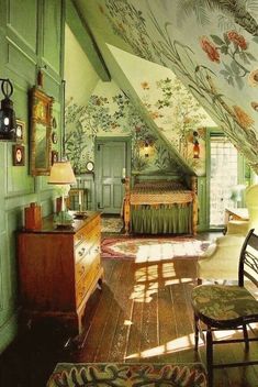 an image of a bedroom with green walls and wooden furniture in the room, which is decorated with floral wallpaper