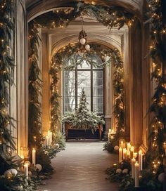 an archway decorated with christmas garland and lit candles