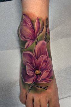 a person's foot with flowers painted on it