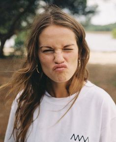 a woman making a face with her eyes closed