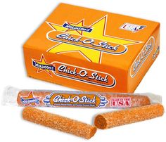 an orange box and two pieces of stick candy are shown in this image, with one piece cut out to show the inside