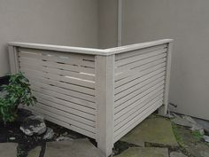 a white wooden fence next to a planter