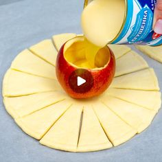 an apple being poured into a can of yogurt next to slices of cheese