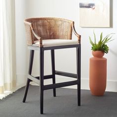 a chair next to a potted plant on the floor