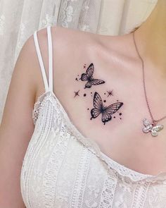 a woman's chest with two butterfly tattoos on her left shoulder and the other side