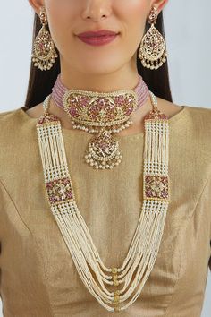 White layered necklace with bead and stone embellishments. Comes with gold plated pendant choker and earrings.
Components: Choker, Long necklace, Pair of earrings
Type: Semi precious stones, Beads
Color: Gold, Red, White
Bead drop detail
Composition: Mixed metal alloy of brass and copper - Aza Fashions Elegant Kundan Necklace With Gold Beads, Gold Jeweled Necklaces For Reception, Elegant Jewelry With Dangling Beads For Reception, Elegant Reception Jewelry With Dangling Beads, Temple Jewelry Style Beaded Necklace For Reception, Temple Jewelry Beaded Necklace For Reception, Gold Beaded Jewelry For Reception, Elegant Gold Beaded Necklace For Reception, Gold Kundan Beaded Necklaces For Reception