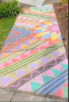 a colorfully painted walkway in front of a house