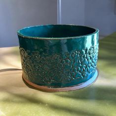 a green bowl sitting on top of a table