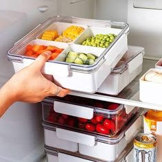 a refrigerator filled with lots of different types of vegetables and fruit in containers on the shelves