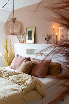 a bed with lots of pillows on top of it