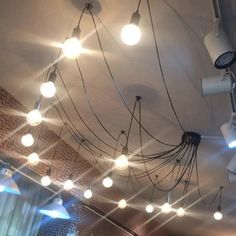 the lights are hanging from the ceiling in the room