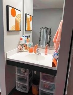 a bathroom with a sink, mirror and drawers