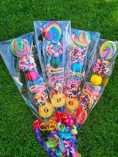 a bunch of lollipops and candy on the grass