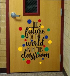 a door decorated with the words, the future of the world is in this classroom