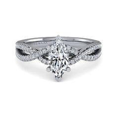 a white gold engagement ring with an oval cut diamond center and twisted shants on the band