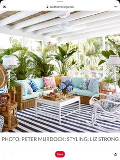 a living room with wicker furniture and tropical plants on the walls, along with blue and white striped rugs