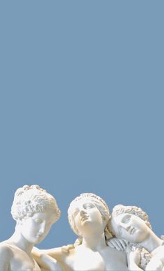 three white marble statues with blue sky in the background