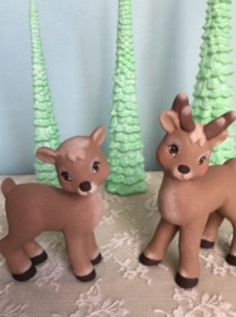 two little deer figurines sitting next to each other