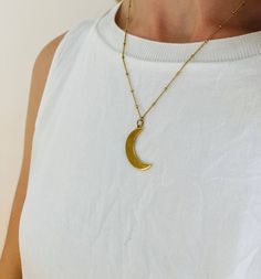 Sliver Moon Charm Necklace on delicate ball + curb chain Gold plated charm and chain Pendant: 1″ Chain length: 16″ Everyday Moon Shaped Necklace With Delicate Chain, Everyday Moon Charm Necklaces, Dainty Metal Necklace With Moon Charm, Everyday Moon Charm Necklace, Moon Charm Round Pendant Chain Necklace As Gift, Silver Chain Necklace With Moon Charm As Gift, Everyday Crescent Moon Charm Necklaces, Everyday Brass Necklace With Moon Charm, Minimalist Metal Moon Charm Necklace