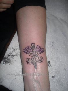 a person with a tattoo on their arm that has an angel and cross on it