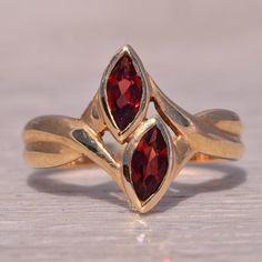 This Stunning Piece, Known As The Double Garnet, Features Two Captivating Marquise Cut Garnets, Each Bezel Set In A Beautiful 14 Karat Yellow Gold Band. The Design Is Both Elegant And Unique, Making It A Perfect Statement Piece For Any Jewelry Collection. This Exquisite Ring Is Currently A Finger Size 6 Yet Can Be Adjusted To Any Finger Size For An Additional Charge Upon Request, Ensuring A Perfect Fit. Yellow Gold Color, Garnet Ring, Jewelry Photography, Garnet Rings, Marquise Cut, Gold Band, Bezel Setting, Womens Jewelry Rings, Gold Bands