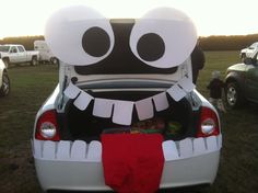 a car with an open trunk decorated to look like a monster