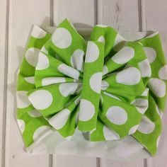 a green and white polka dot hair bow