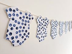 blue and white polka dot tie garland hanging on the wall