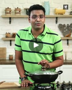 a man standing in front of a frying pan on top of a stovetop