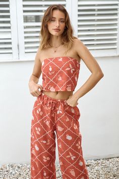 Infuse your summer wardrobe with vibrancy with our Tropical Punch Strapless Crop Top in Orange. Whether you're lounging poolside or dancing at a beach party, this top brings a burst of tropical flair to your ensemble, ensuring you stand out with style and confidence. Pair with the matching Tropical Punch Pants. Tropical Two Piece Outfit, Spring Beach Sleeveless Tube Top, Beachwear Tops For Summer Outings, Spring Vacation Sleeveless Tube Top, Sleeveless Tube Top For Spring Vacation, Strapless Cotton Top For Vacation, Beachwear Tops For Summer Beach Season, Beachwear Tops For Summer Beach Outings, Beach Season Tops For Summer Outings