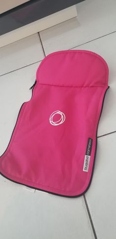 a pink oven mitt sitting on the floor