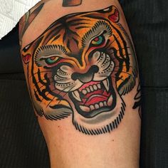 a close up of a person's arm with a tattoo on it and a tiger