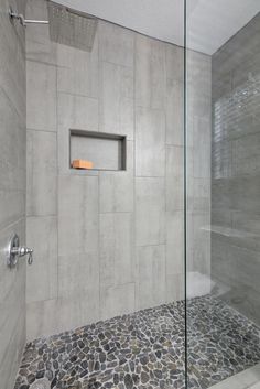 a walk in shower sitting next to a glass door with a window on the side