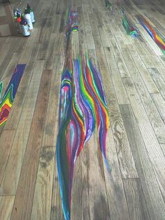 the floor is covered in multi - colored paint and has been painted with different colors