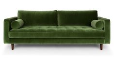 a green velvet couch with two pillows on it's arms and legs, sitting in front of a white background