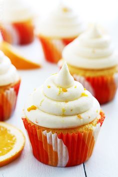 cupcakes with white frosting and orange slices