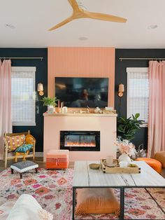 the living room is decorated in pink and blue with pops of color on the walls