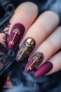 Embrace the spooky season with these matte burgundy nails featuring golden skeletons and keys. These elegant Halloween nails are sure to make a statement. Head over to nailhow.com for more unique nail designs. Save this pin! Halloween Gothic Nails, Halloween Wedding Nail Ideas, Victorian Gothic Nails, Nails Acrylic Wedding, Tombstone Nails, Spooky Wedding Nails, Victorian Style Nails, Fancy Halloween Nails, Skull Nails Acrylic