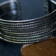 "Engraving oxidized sterling silver stack cuff bracelet(FBA) Bracelet measure: 6\" L (end to end) X 1.3\" W Weight:49.36 g All items are hand crafted by me, Sirilak Samanasak in Chiang Mai, Thailand. Each piece is one of a kind and the item pictured is the exact item that will ship. Every gemstone is hand selected for its quality and beauty and are hand set into settings and final jewelry pieces. JEWELRY CARE Most jewelry in my shop is sterling silver which can easily be cleaned and re polished Elegant Metal Cuff Bracelet With Oxidized Finish, Elegant Oxidized Metal Cuff Bracelet, Unique Oxidized Finish Cuff Bangle, Unique Oxidized Cuff Bracelet Bangle, Unique Oxidized Metal Cuff Bracelet, Unique Metal Cuff Bracelet With Oxidized Finish, Modern Gunmetal Jewelry With Oxidized Finish, Unique Oxidized Metal Bangle, Unique Metal Bangle With Oxidized Finish