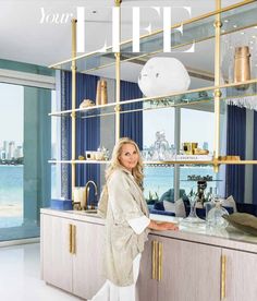 a woman standing in front of a kitchen counter