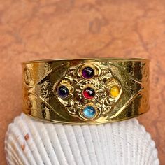 Estate/ vintage14KT yellow gold Etruscan/ Byzantine cuff bracelets with cabochon gemstones An amazing, colorful and high quality cuff! Weight: 15 grams Stamped 14K Italy Made in Italy Width: 28mm at widest point Tapers in back Semi-flexible Old-world charm to this piece Makes a special + unforgettable gift Check out all our gold cuff bracelets + entire jewelry collection! Please let us know if you have any questions. Thank you, Legacy Saint Jewelry Gemstone Cuff Bracelet, Saint Jewelry, Cuff Bangle Bracelet, Gold Bracelet Cuff, Gold Cuffs, Tiny Stud Earrings, Sterling Silver Cuff Bracelet, Sterling Silver Flowers, Sterling Silver Cuff